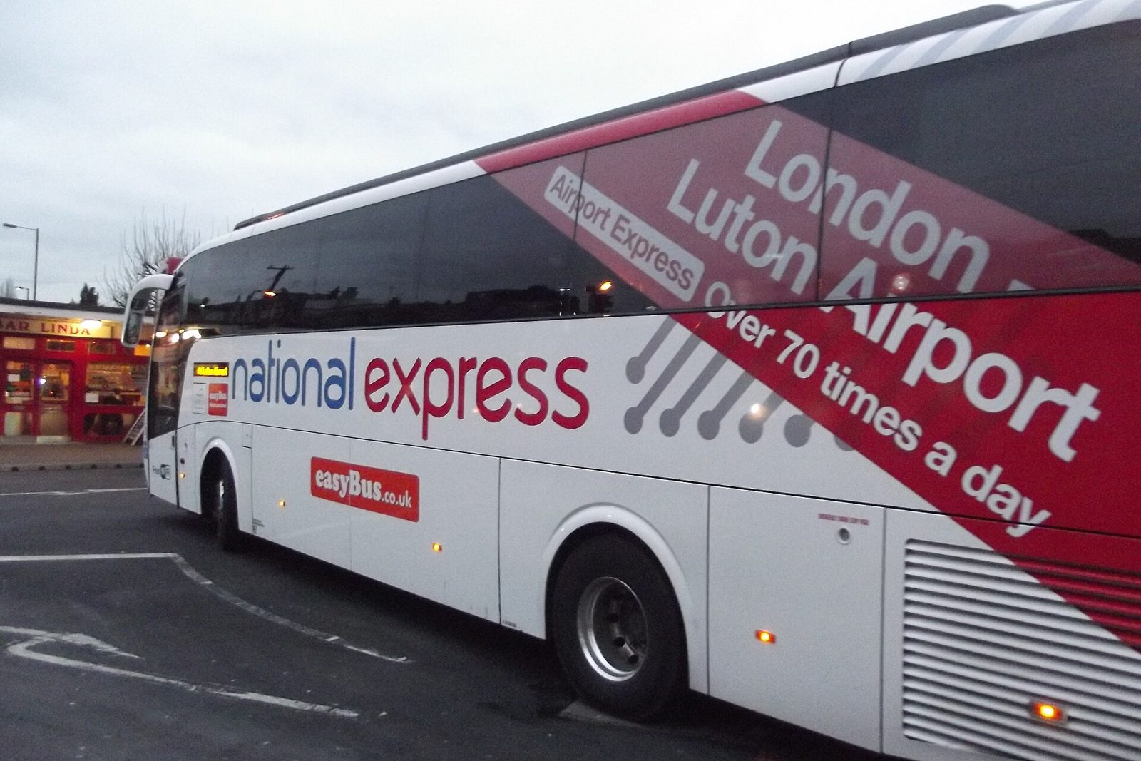 Full-size touring coach parked ready to board a large group