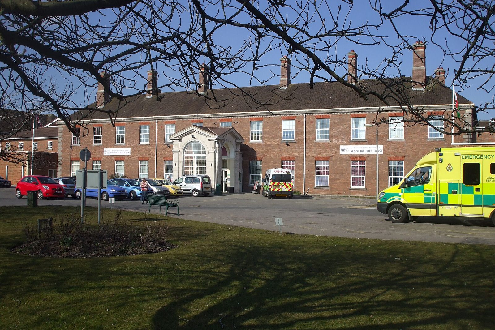 Private car waiting at a hospital main entrance for a patient transfer